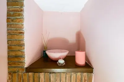 a room with a bowl and two candles on a table at Colosseum Rione Monti 1 in Rome