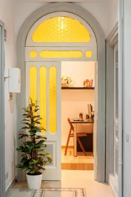 an entryway with an arched doorway with a yellow window at El Dorado Colosseum in Rome