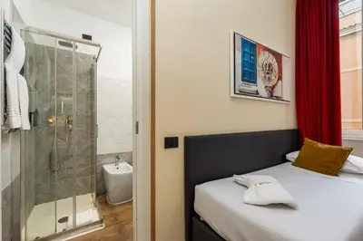 a small bedroom with a shower and a bed at Seven in Rome
