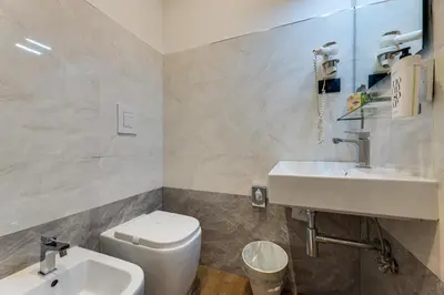 a bathroom with a white toilet and a sink at Seven in Rome