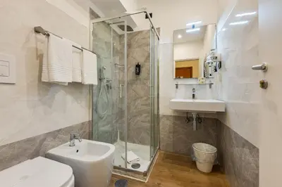 a bathroom with a shower and a toilet and a sink at Seven in Rome