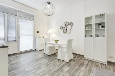 a kitchen and dining room with a white table and chairs at The Miki House in Rome
