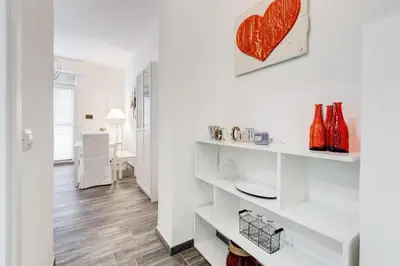 a living room with white walls and wooden floors at The Miki House in Rome