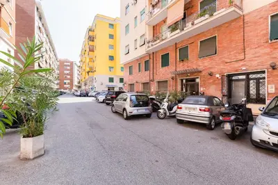 a street with cars parked on the side of the road at The Miki House in Rome