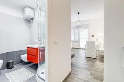 a bathroom with a red vanity and a red cabinet at The Miki House in Rome