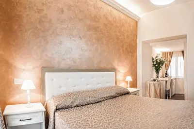 a bedroom with a large bed and a wall at Relais de l'Opera in Rome
