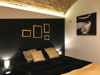 a bedroom with a black bed and two lamps at CasAphrodite in Rome