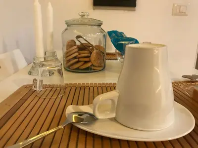 a table with a tea kettle and a plate and candles at CasAphrodite in Rome