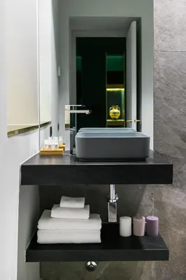 a bathroom with a sink and towels on a shelf at Etruscan Luxury Suites in Rome