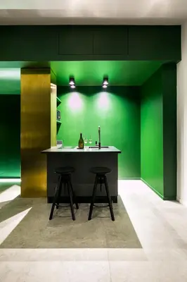 a green room with a counter and two stools at Etruscan Luxury Suites in Rome
