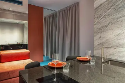 a dining room with a table with wine glasses on it at Etruscan Luxury Suites in Rome