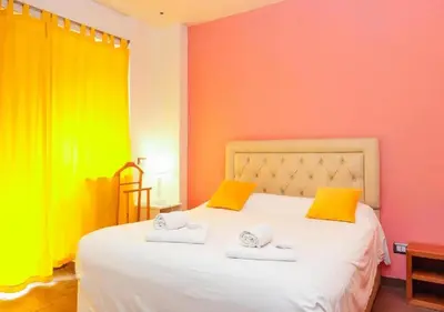 a bedroom with colorful walls and a bed with two towels at Aida Charming Rooms in Rome