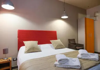a bedroom with a large bed with two towels at Aida Charming Rooms in Rome