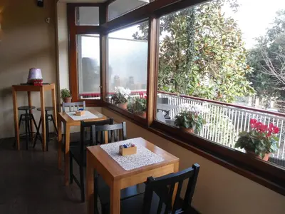 a restaurant with two tables and two windows at Aida Charming Rooms in Rome