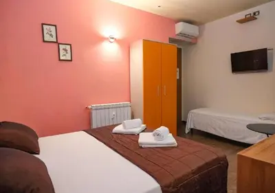 a bedroom with a bed with two towels on it at Aida Charming Rooms in Rome