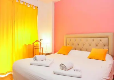 a bedroom with colorful walls and a bed with towels at Aida Charming Rooms in Rome