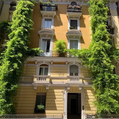 a building with plants growing on the side of it at Clementi Portrait in Rome