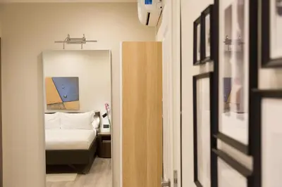 a bedroom with a bed and a mirror at Clementi Portrait in Rome