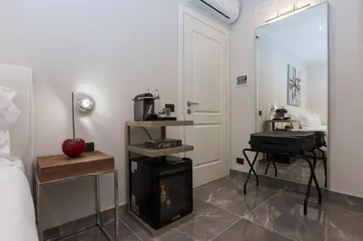 a bedroom with a fireplace and a bed and a mirror at Clementi Portrait in Rome