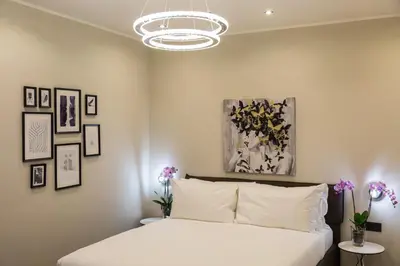 a bedroom with a white bed and pictures on the wall at Clementi Portrait in Rome