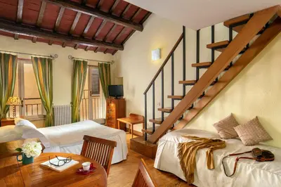 a bedroom with two beds and a staircase at Bollo Apartments in Rome