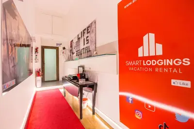 a red sign in a room with a red carpet at Smart Lodgings Plus in Rome