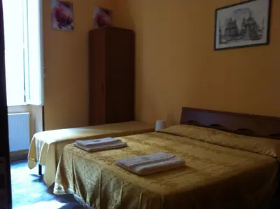 a bedroom with two beds with towels on them at San Daniele Bundi House in Rome