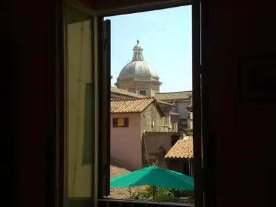 a view from a window of a building with an umbrella at San Daniele Bundi House in Rome