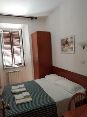 a bedroom with a bed with two towels on it at San Daniele Bundi House in Rome