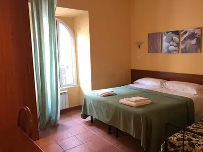 a bedroom with two beds and a window at San Daniele Bundi House in Rome