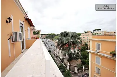 a view of a city from a balcony of a building at B&B Lost in Rome in Rome