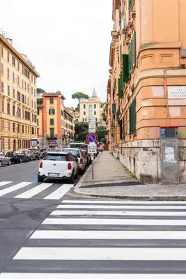 a crosswalk with cars parked on a city street at Alea Home Roma in Rome