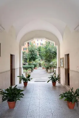 a hallway with potted plants in a building at Alea Home Roma in Rome