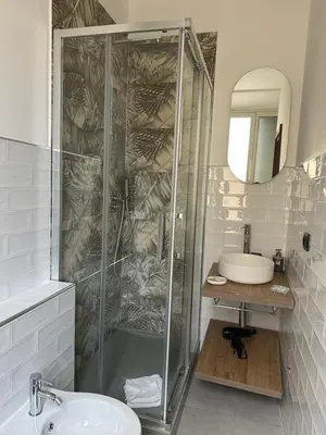 a white bathroom with a sink and a toilet at Alea Home Roma in Rome