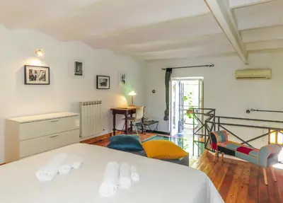a bedroom with a bed and a living room at Casa del Moro - romantic loft in Trastevere in Rome