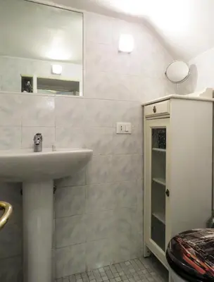 a bathroom with a sink and a mirror at Casa del Moro - romantic loft in Trastevere in Rome