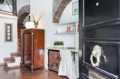 a room with a table and a black fireplace at Cedro Terrace&Jacuzzi - Loft in Trastevere in Rome