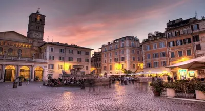 a city square with a clock tower and buildings at Cedro Terrace&Jacuzzi - Loft in Trastevere in Rome