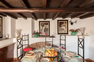 a dining room with a glass table with fruit on it at Cedro Terrace&Jacuzzi - Loft in Trastevere in Rome
