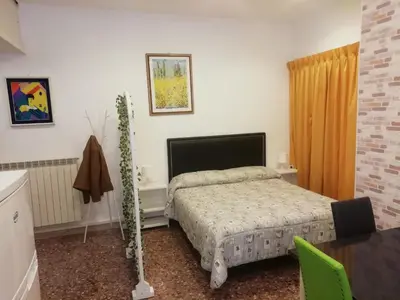 a bedroom with a bed and a table at Apartment Urbino 33 in Rome