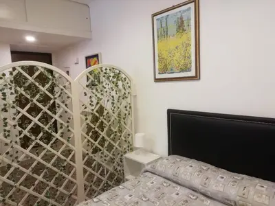 a bedroom with a bed and a glass partition at Apartment Urbino 33 in Rome