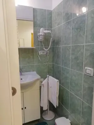 a bathroom with a sink and a toilet and a mirror at Apartment Urbino 33 in Rome