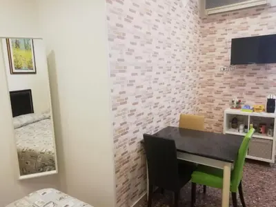 a dining room with a table and chairs and a bedroom at Apartment Urbino 33 in Rome