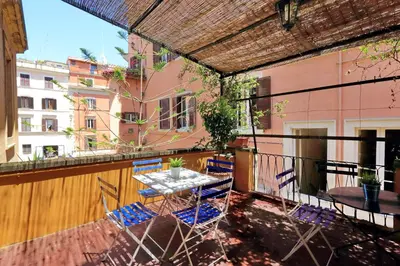 a patio with a table and chairs on a balcony at Restart Zingari Rome in Rome