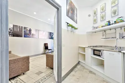 a kitchen with white cabinets and a sink at Restart Zingari Rome in Rome