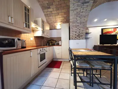 a kitchen with a table and a microwave at Colosseo Home - 29061 in Rome