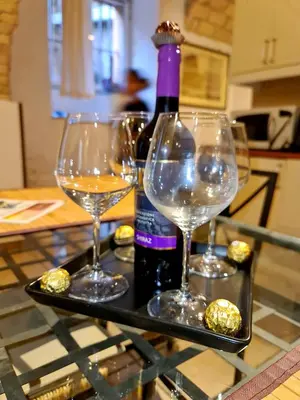 a tray with two wine glasses and a bottle of wine at Colosseo Home - 29061 in Rome