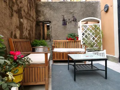 a patio with two chairs and a table and a table sidx sidx sidx at Colosseo Home - 29061 in Rome