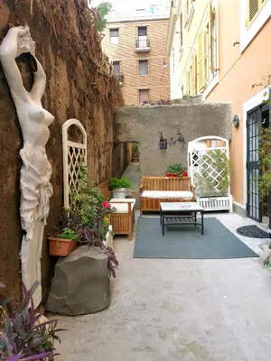 a courtyard with a statue of a woman on a wall at Colosseo Home - 29061 in Rome