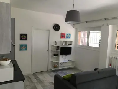 a living room with a couch and a television at OASI METROPOLITANA Apartment in Rome